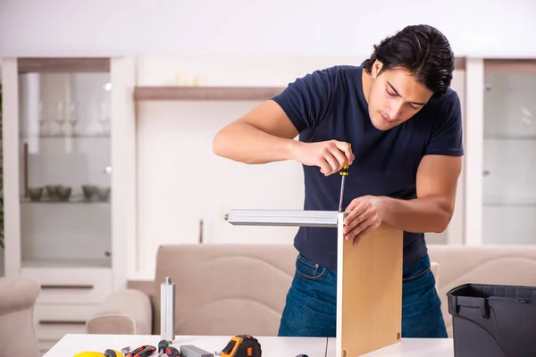 Young man repairing furniture at home — Stock Photo, Image