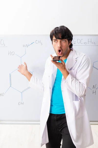 Young student chemist in the classroom — Stock Photo, Image
