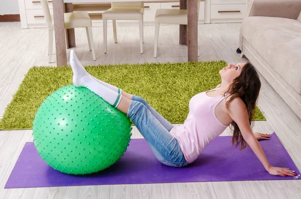 Young beautiful woman doing exercises at home — Stock Photo, Image