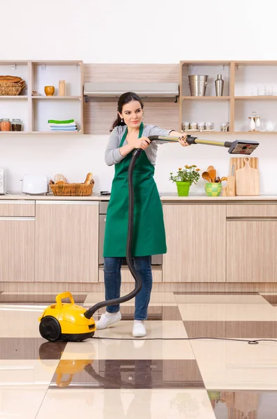 Young female contractor doing housework — Stock Photo, Image