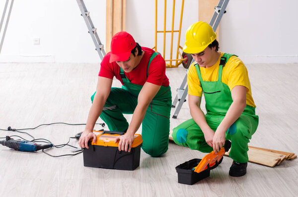 Two workers contractors working indoors  