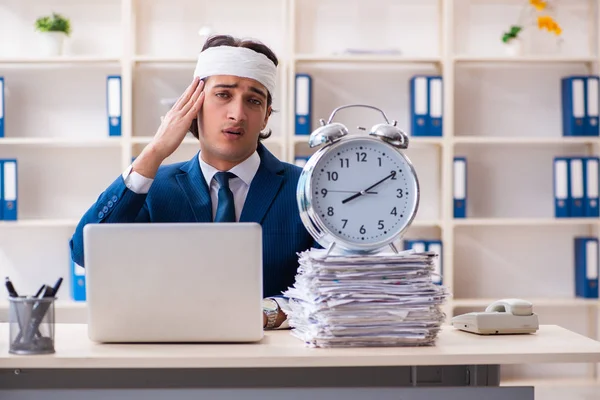 Head injured male employee working in the office