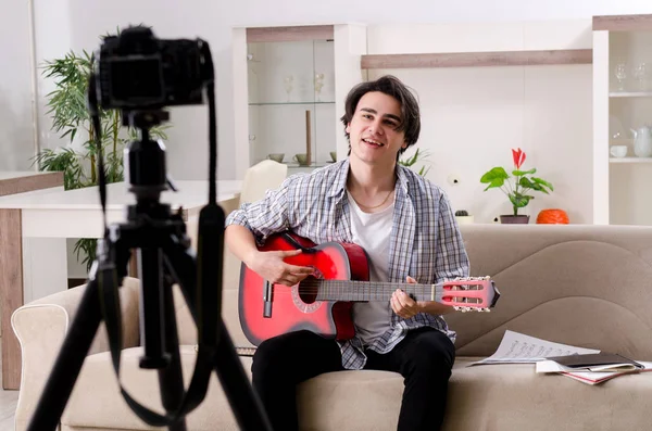 Young guitar player recording video for his blog — Stock Photo, Image