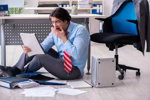 Young male employee unhappy with excessive work — Stock Photo, Image