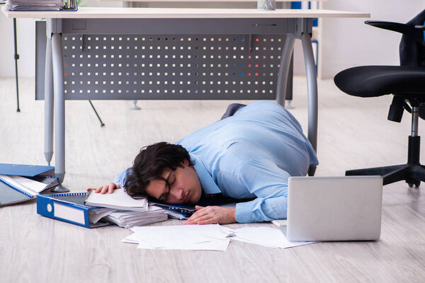 Young male employee unhappy with excessive work 