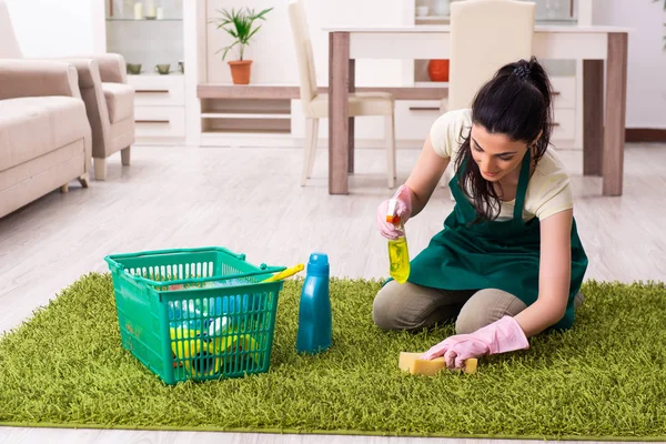 Young female contractor doing housework — Stock Photo, Image