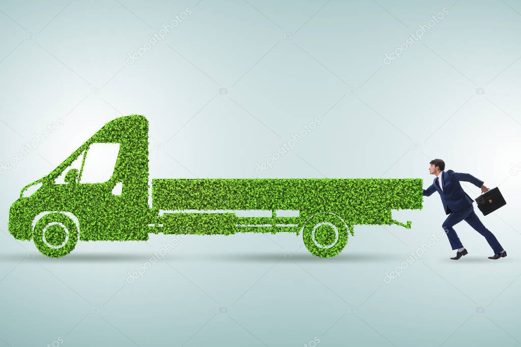 Businessman with green ecological vehicle