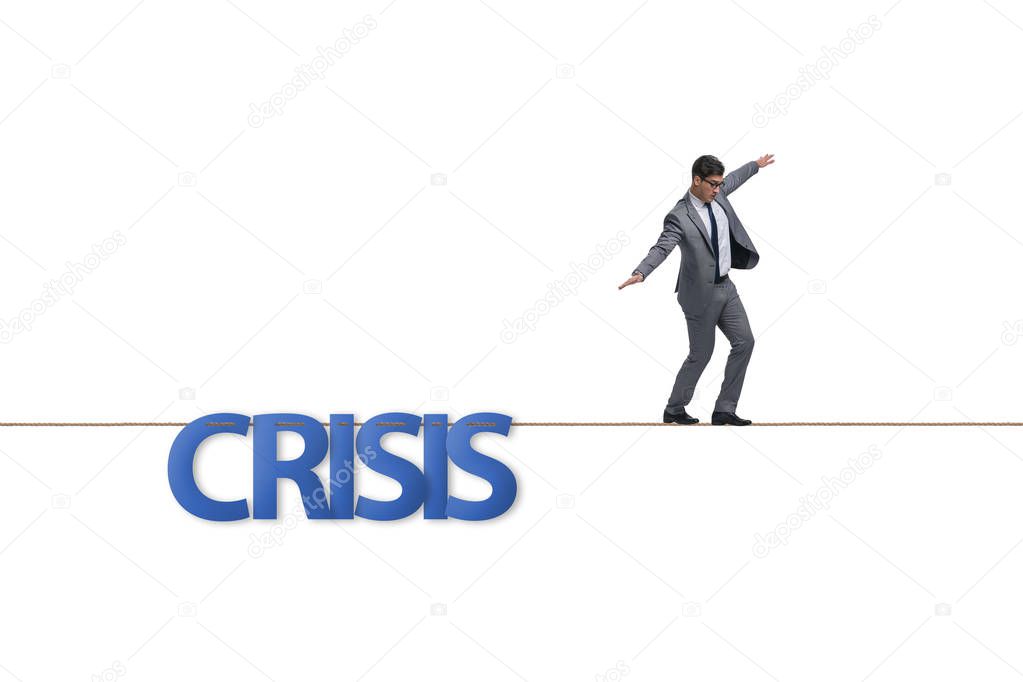 Crisis concept with businessman walking on tight rope