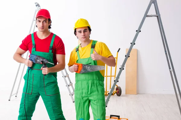 Two workers contractors working indoors