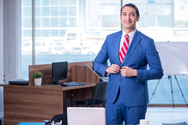 Young handsome businessman sitting in the office — Stock Photo, Image