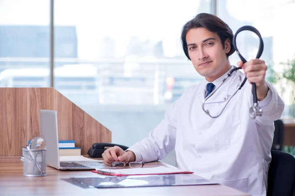 Young handsome doctor working in the clinic — Stock Photo, Image