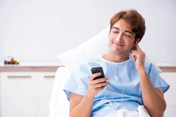 Young male patient lying on couch in hospital