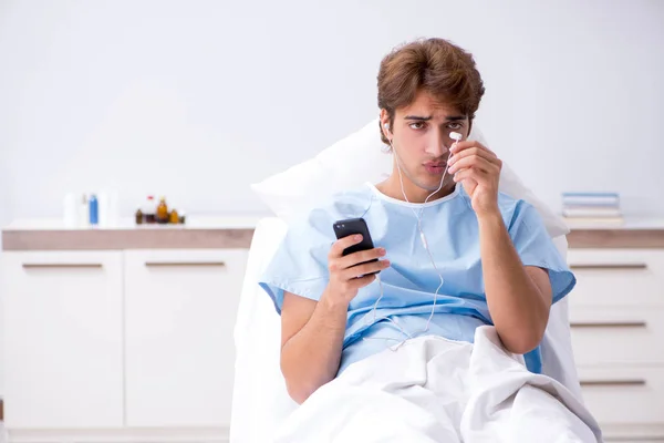 Young male patient lying on couch in hospital