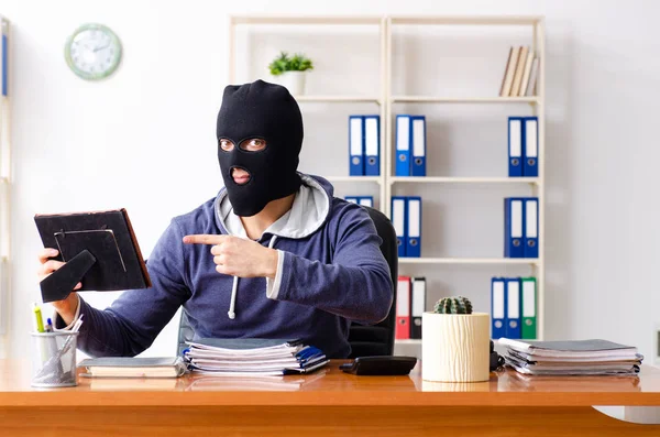 Männlicher Dieb mit Sturmhaube im Büro — Stockfoto