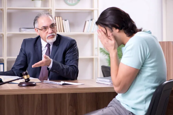 Young man visiting experienced male lawyer — Stock Photo, Image