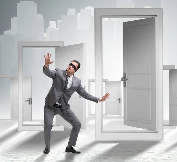 Confused businessman in front of doors — Stock Photo, Image