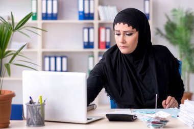Ofiste çalışan tesettürlü kadın muhasebeci. 