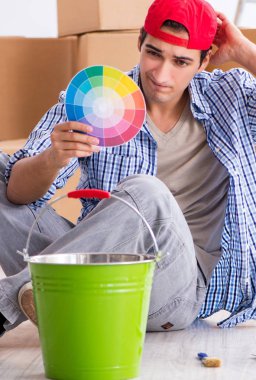 Ev dekorasyonu için renk seçen genç bir ressam müteahhit.