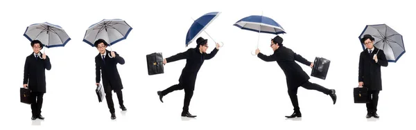 Young man holding suitcase and umbrella isolated on white — Stock Photo, Image