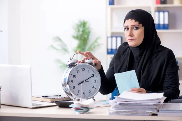 Female employee bookkeeper in hijab working in the office