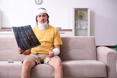 Evde kazadan sonra iyileşen genç adam. 