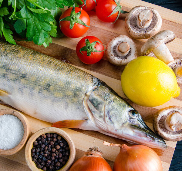 Uncooked fish on cutting board in meal preparation concept