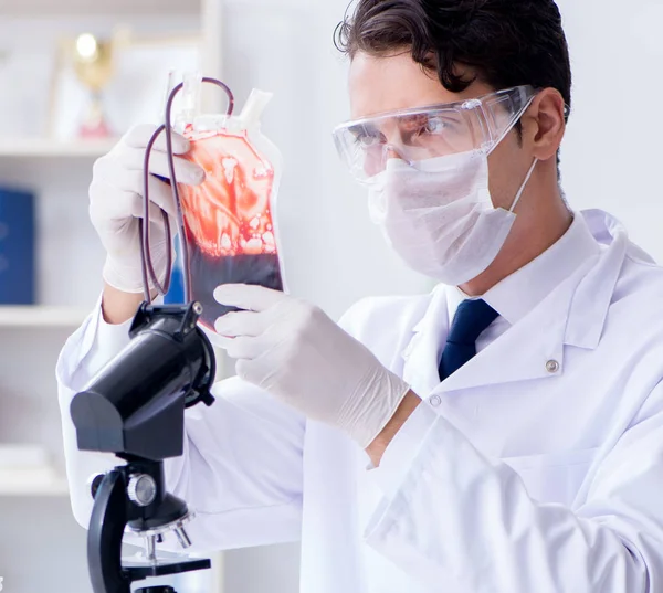 Médico trabajando con muestras de sangre en el laboratorio de la clínica hospitalaria —  Fotos de Stock