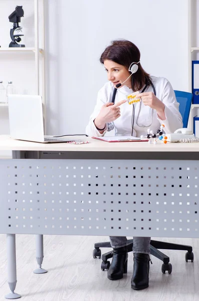 Middle-aged female doctor in telemedicine concept — Stock Photo, Image