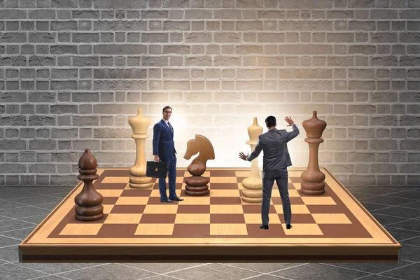 Businessman in large chess board in strategy concept — Stock Photo, Image