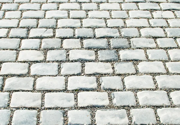 Camino pavimentado con piedras de guijarro para su fondo —  Fotos de Stock