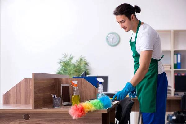 Young handsome contractor cleaning the office — Stock Photo, Image