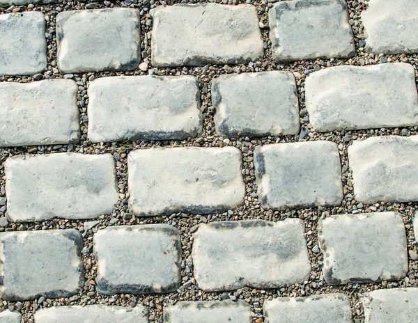 Estrada pavimentada com pedras de calhau para o seu fundo — Fotografia de Stock