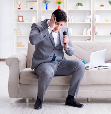 Üzgün işadamı ofiste şarkı söylüyor.