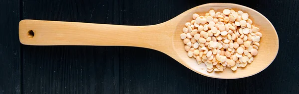 Spoons filled with uncooked lentil for soup — Stock Photo, Image