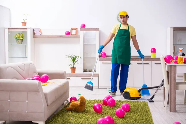 Young male contractor doing housework after party — Stock Photo, Image