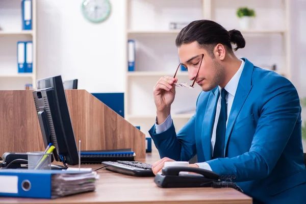 Jovem empresário bonito sentado no escritório — Fotografia de Stock