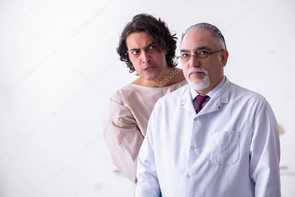 Aged male doctor psychiatrist examining young patient 