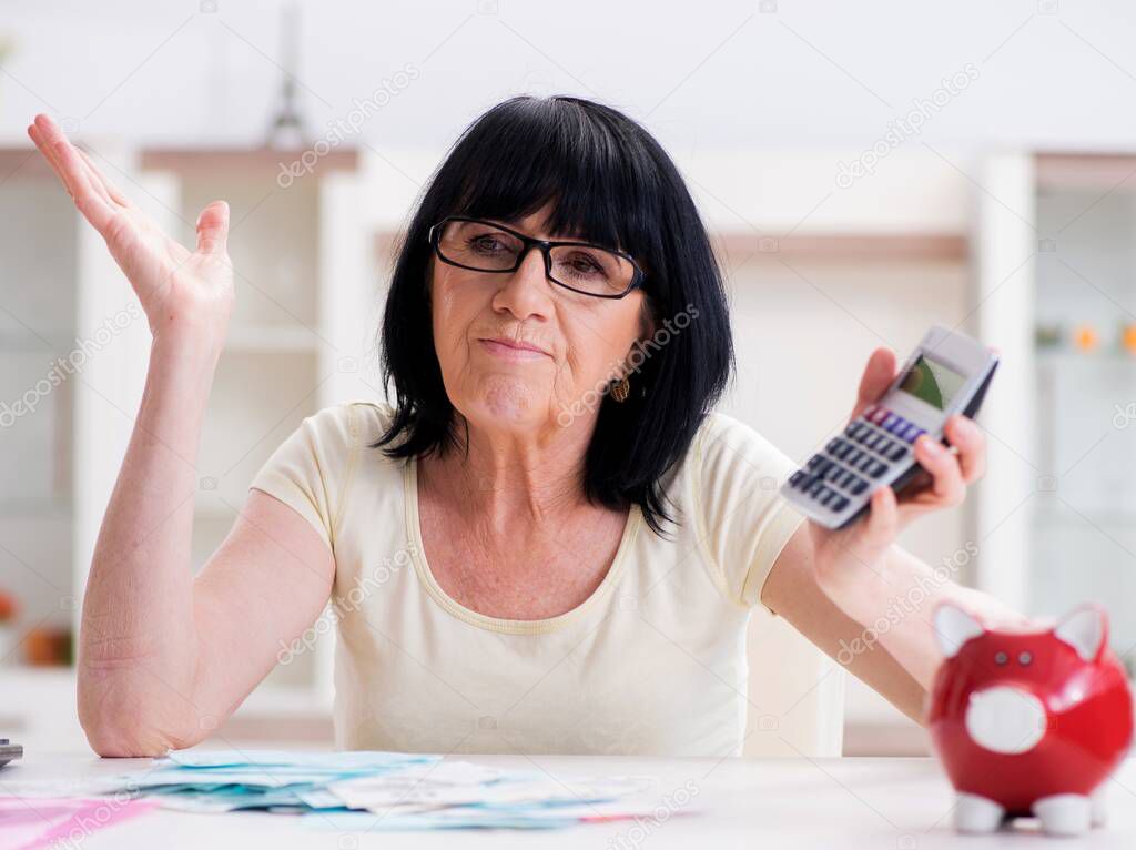 Mature woman trying to reconcile her bills