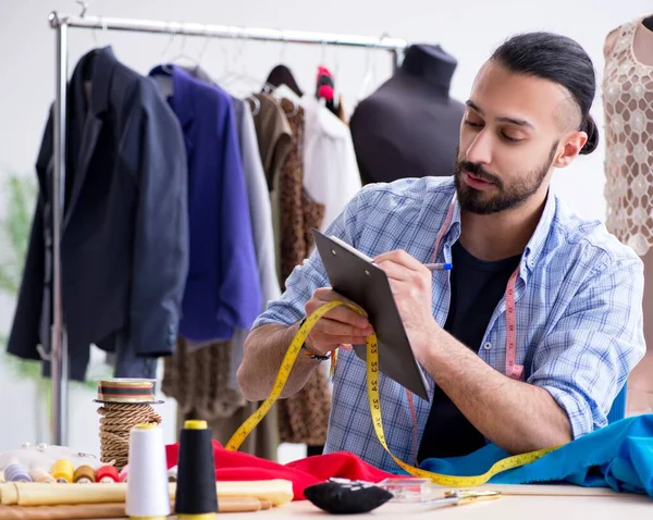 Male tailor working in the workshop on new designs — Stock Photo, Image