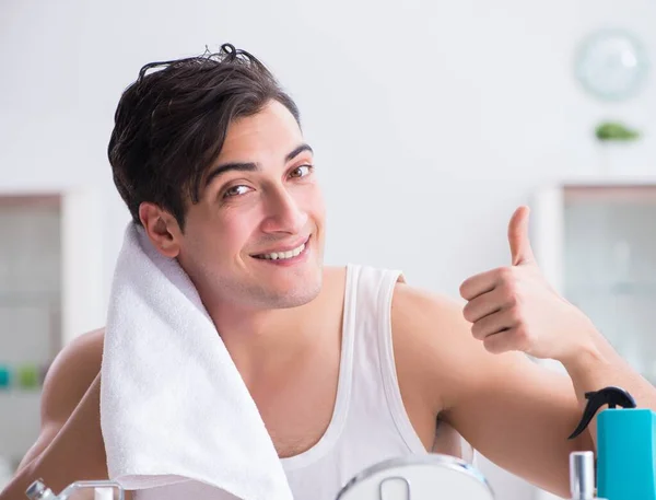 Jovem homem bonito olhando no espelho — Fotografia de Stock