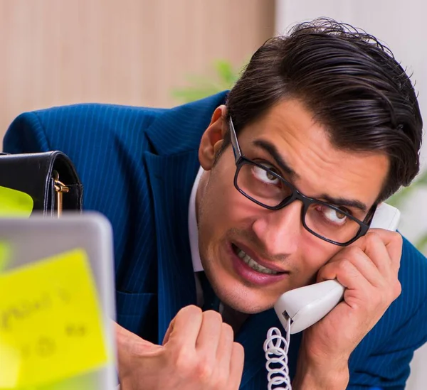 Businessman with reminder notes in multitasking concept