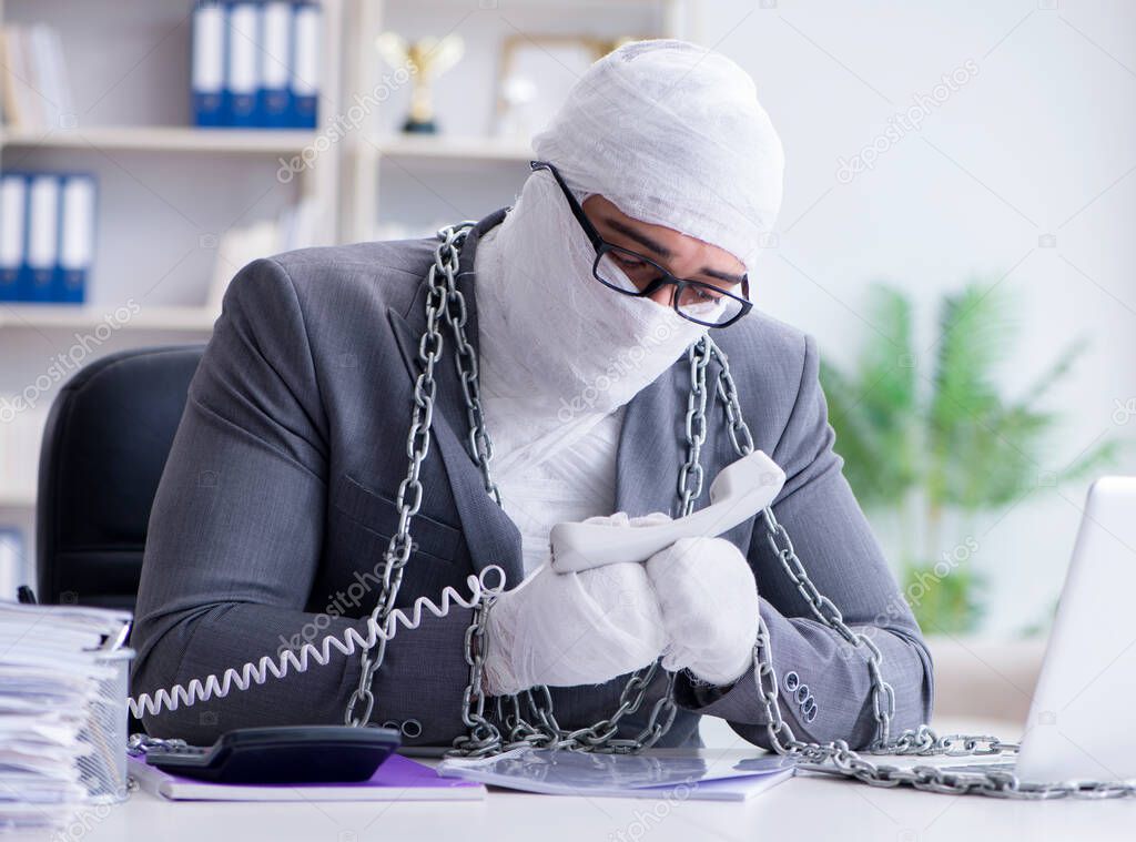 Bandaged businessman worker working in the office doing paperwor