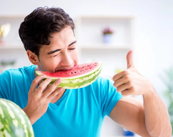 Man eating watermelon at home — Stock Photo, Image