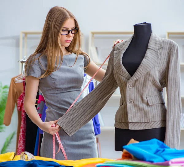 Jeune femme tailleur travaillant en atelier sur une nouvelle robe — Photo