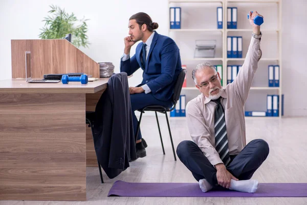 Δύο υπάλληλοι που κάνουν σωματικές ασκήσεις στο χώρο εργασίας — Φωτογραφία Αρχείου