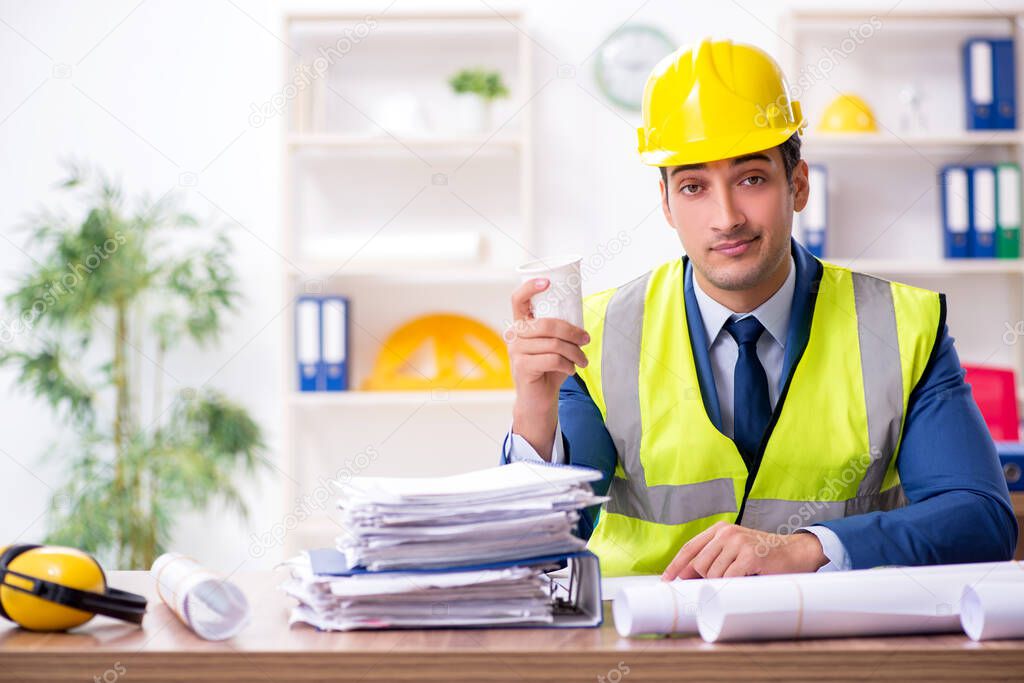 Young male architect working in the office