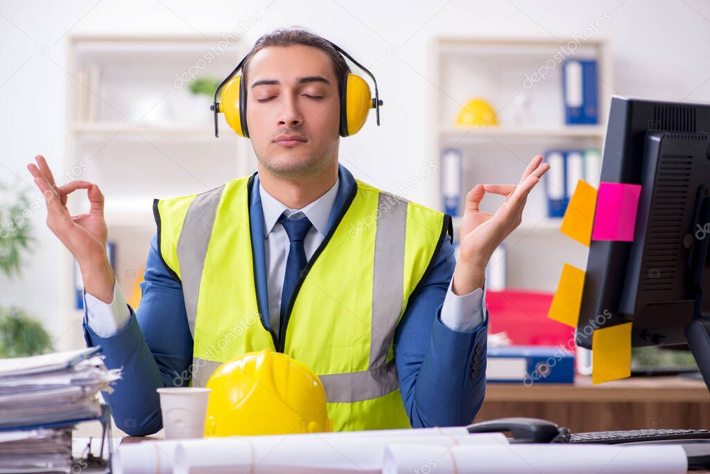 Young male architect working in the office