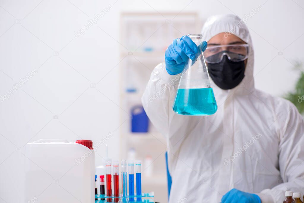 Young male chemist working in medicine lab