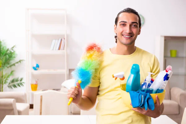 Young male contractor doing housework at home