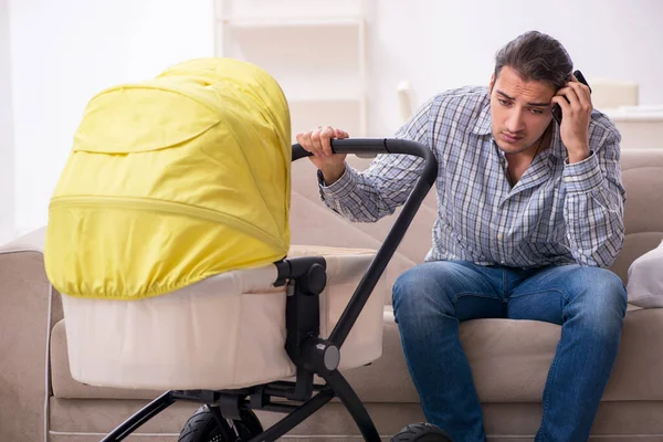 Young father looking after newborn baby at home — Stock Photo, Image